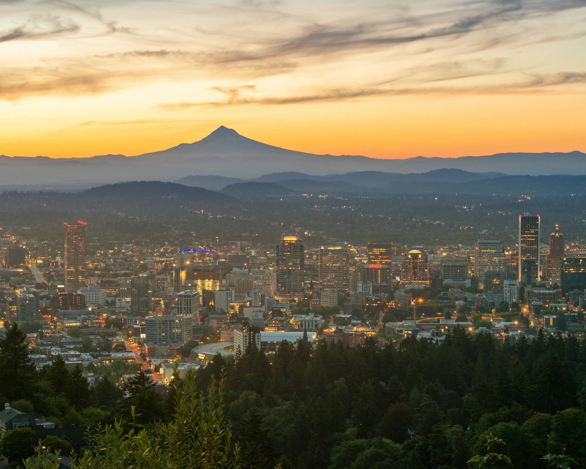 Downtown Portland at dawn with Mount Hood on the horizon, seen from the West Hills.
