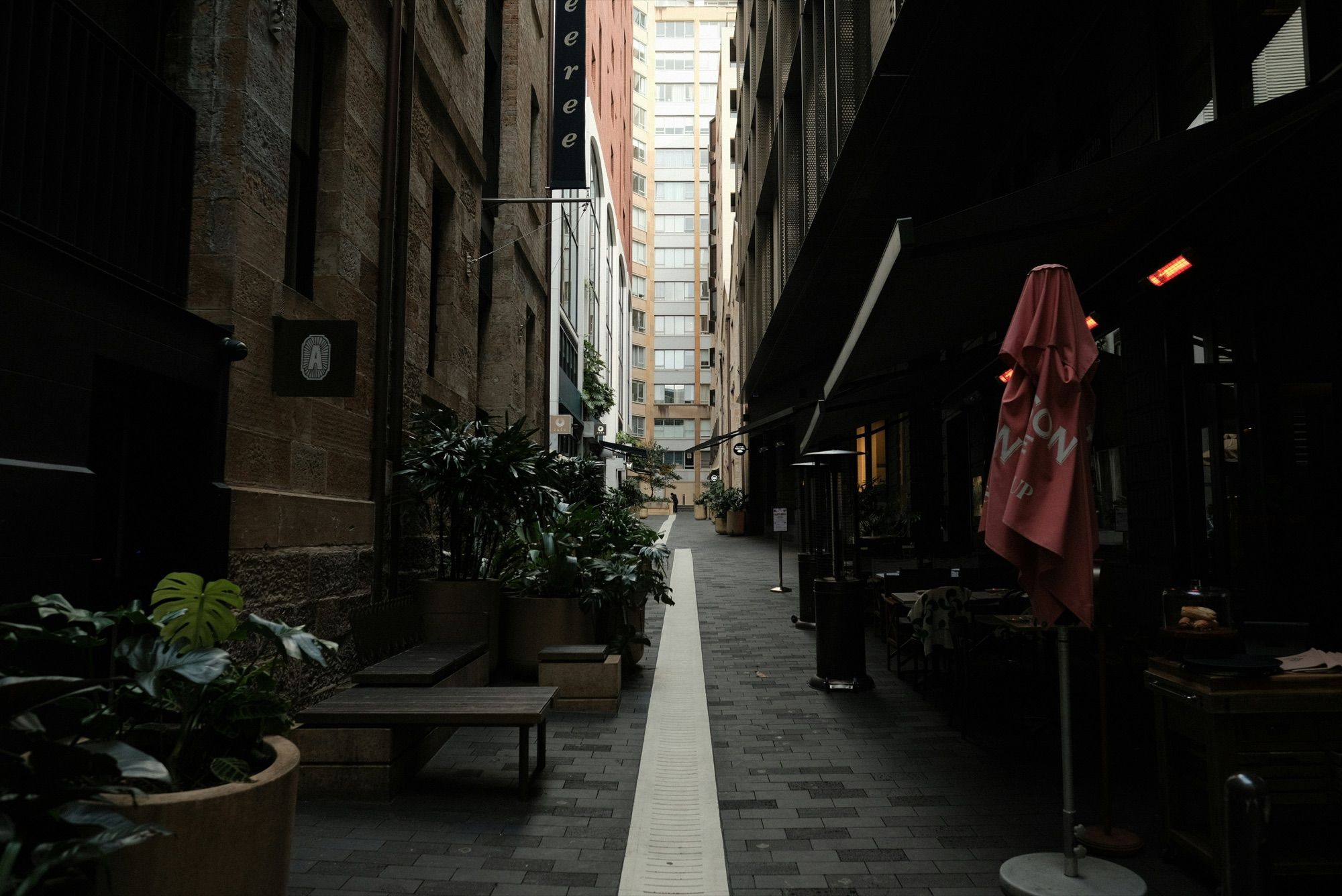 Restaurant tables and umbrellas in a narrow laneway near Circular Quay, Sydney