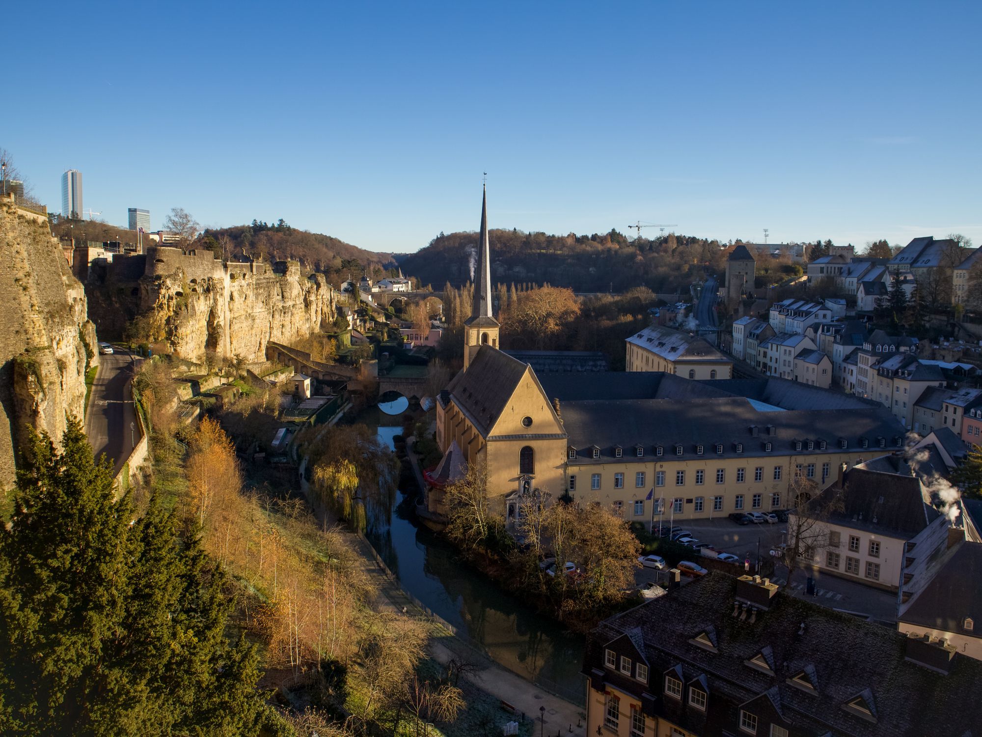 The Alzette valley and the Neumünster Abbey in the Grund quarter of Luxembourg City, with limestone cliffs on the left.