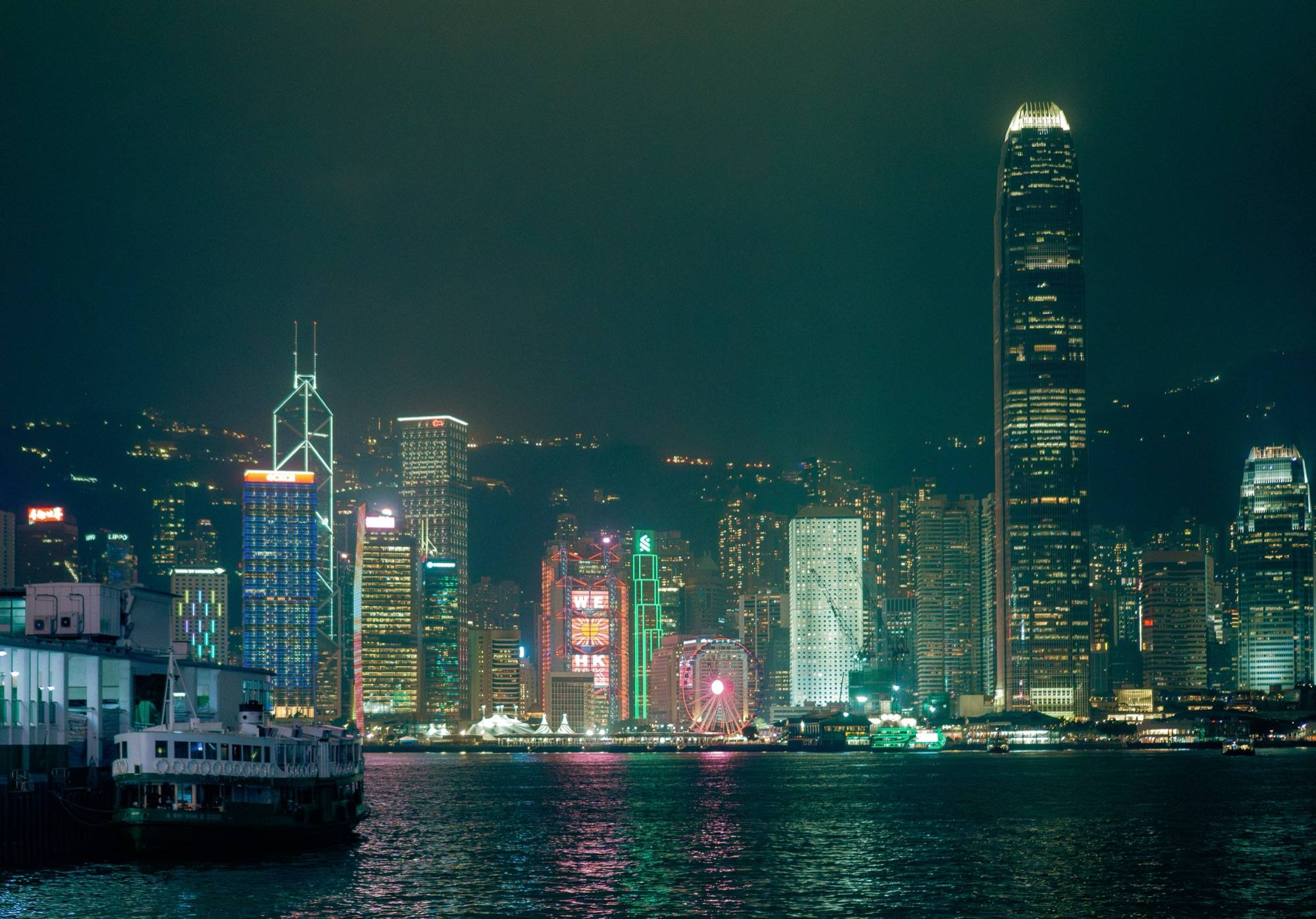 The Hong Kong Island skyline lit up at night across Victoria Harbour