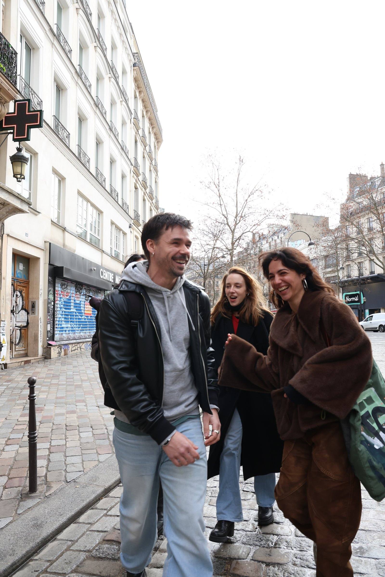 Two walkers on a cobbled street with three more friends behind them
