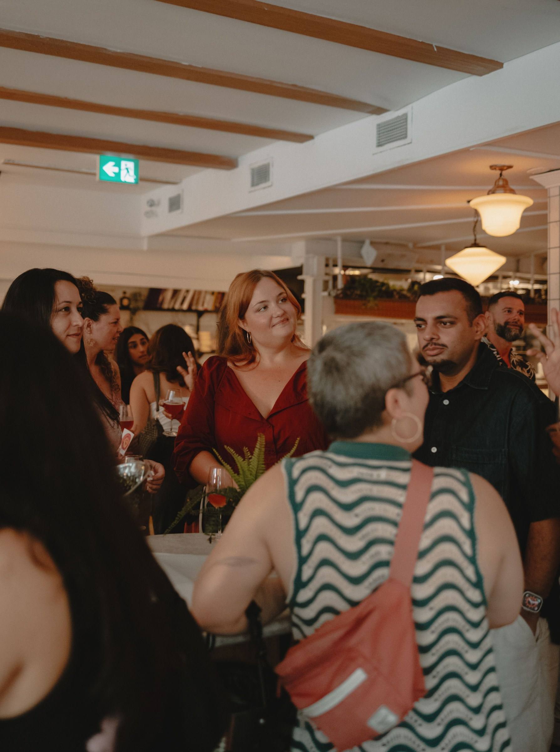 Guests mingling and laughing before a Timeleft dinner