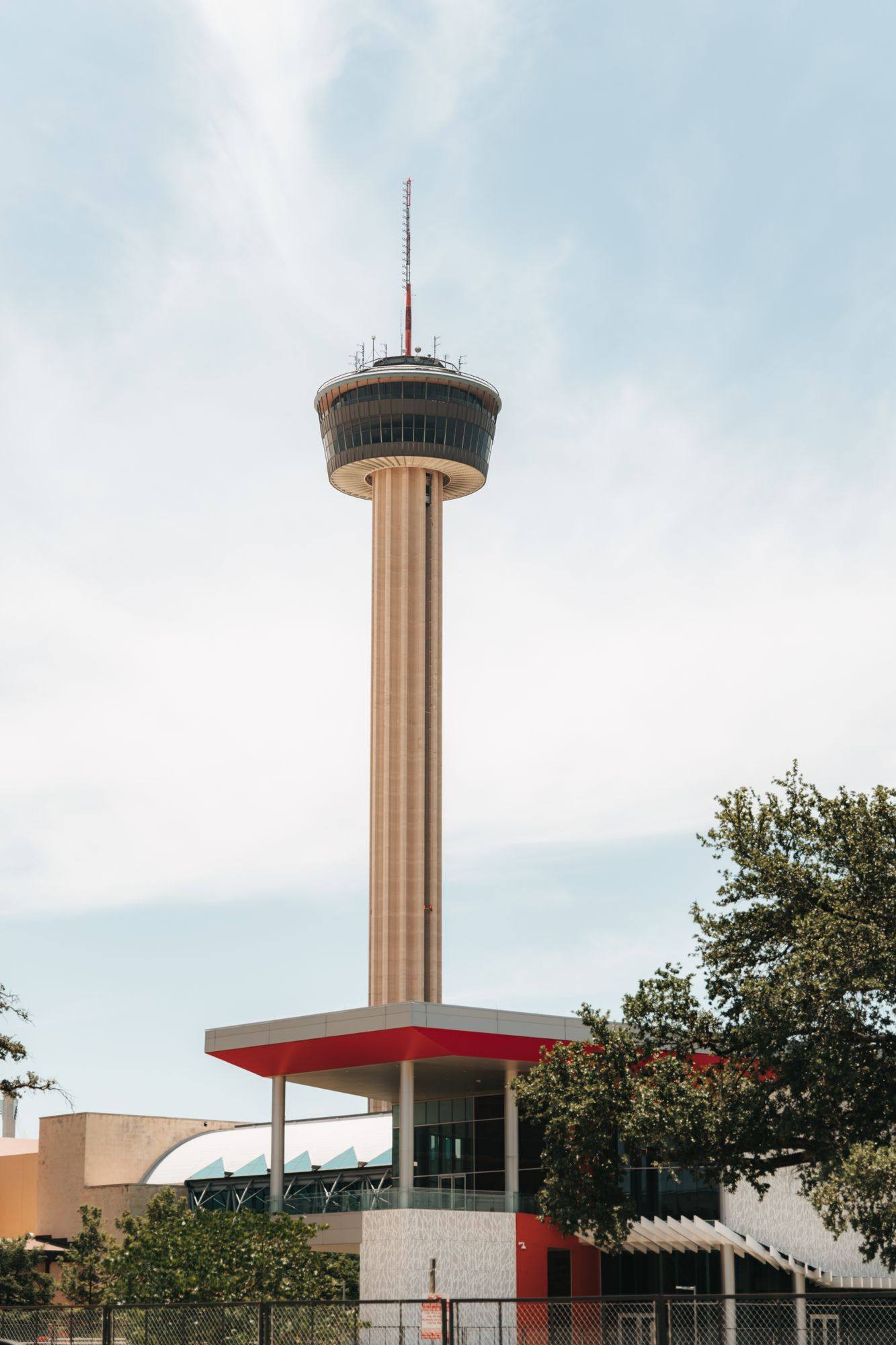 The Tower of the Americas rising above San Antonio against a pale sky.