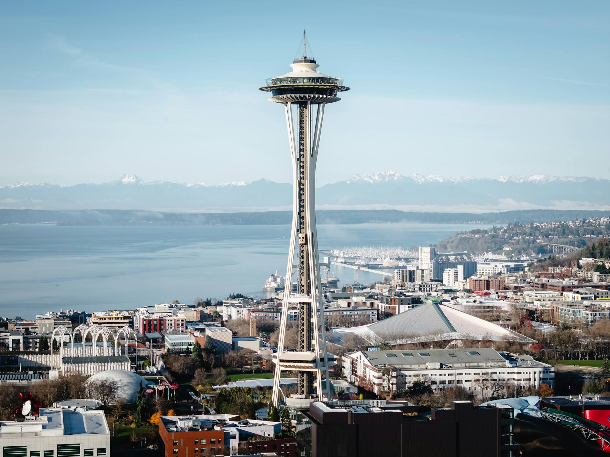 The Space Needle in Seattle, with Elliott Bay and the Olympic Mountains in the background.