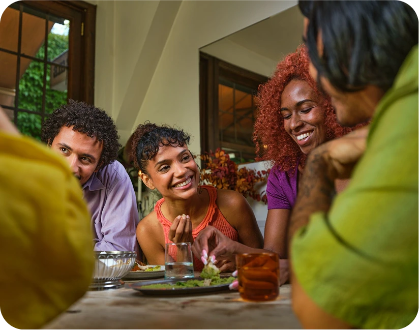 People laughing over dinner at a Timeleft table