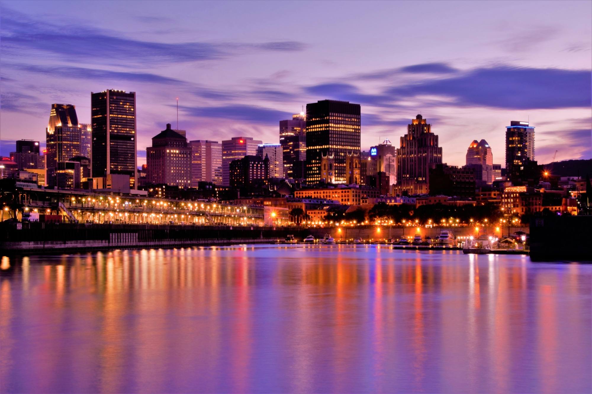 Downtown Montreal’s skyline at dusk, seen across the harbour