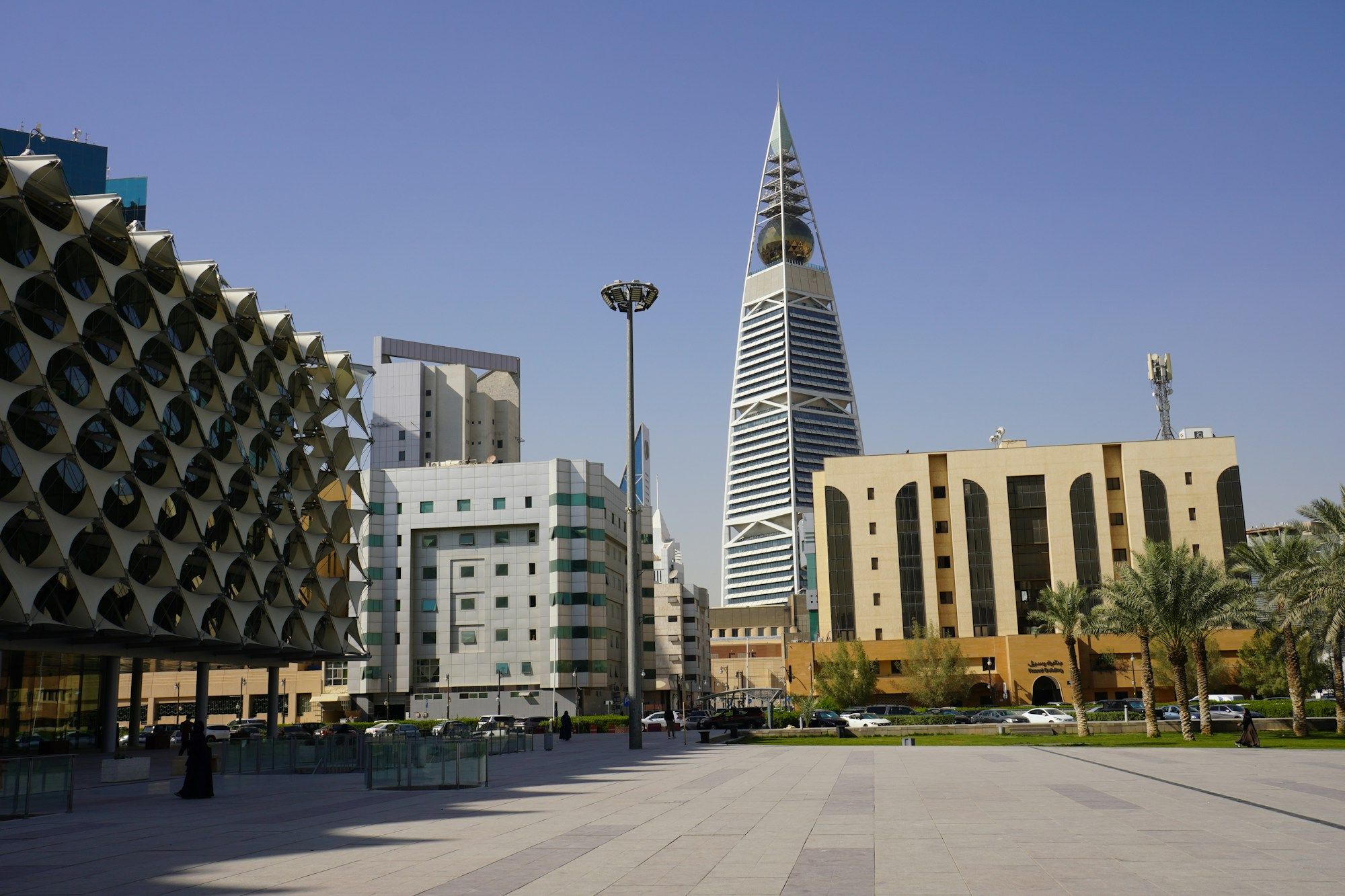 The Al Faisaliah Tower rising behind the lattice facade of the King Fahd National Library in Riyadh.