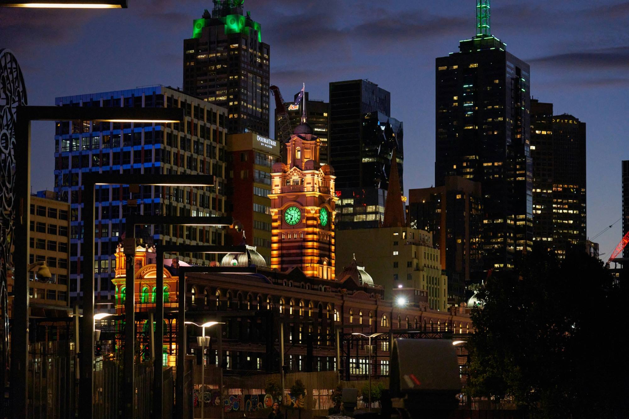 Flinders Street Station and Melbourne’s towers at first light, seen from Southbank