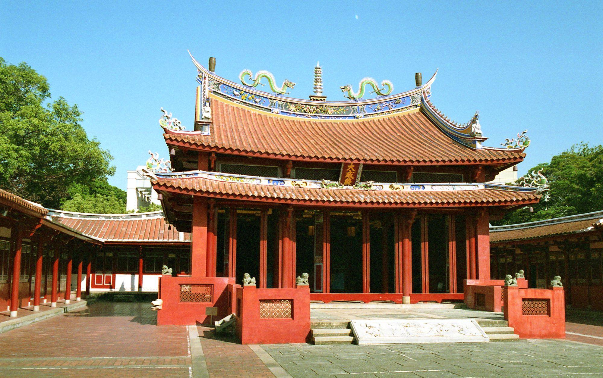 The main hall of the Confucius Temple in Tainan, with its red walls and decorated tiled roof.