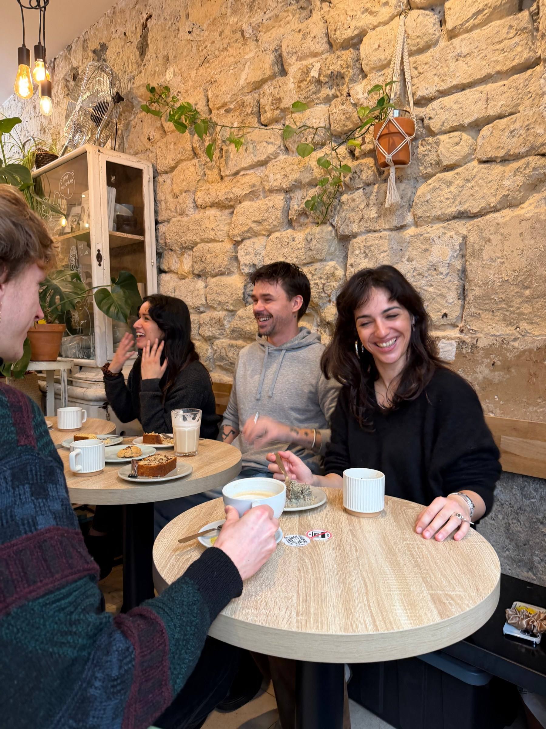 A group around small café tables at a Timeleft coffee