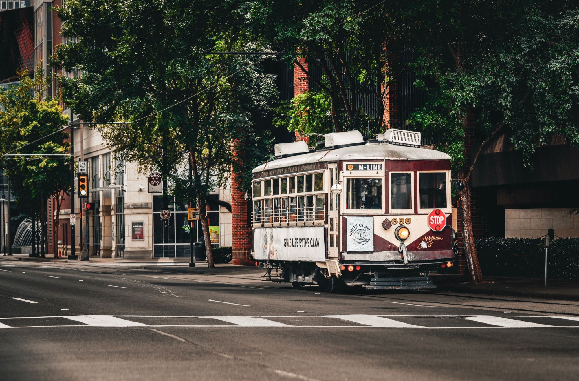 A vintage M-Line streetcar on a street in Dallas