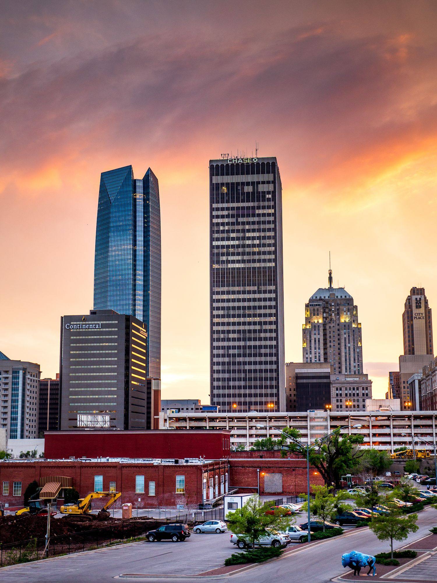 Downtown Oklahoma City skyscrapers at sunset, with the glass Devon Tower on the left.