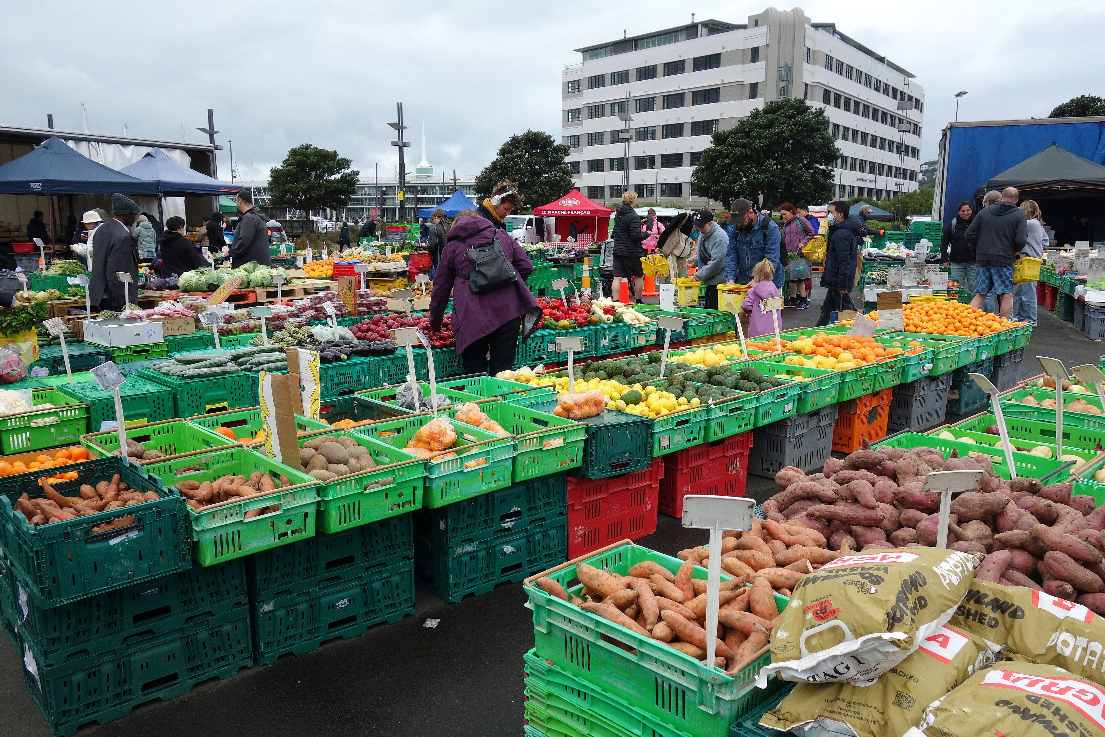 Shoppers browsing crates of vegetables at the Harbourside Market in Wellington.