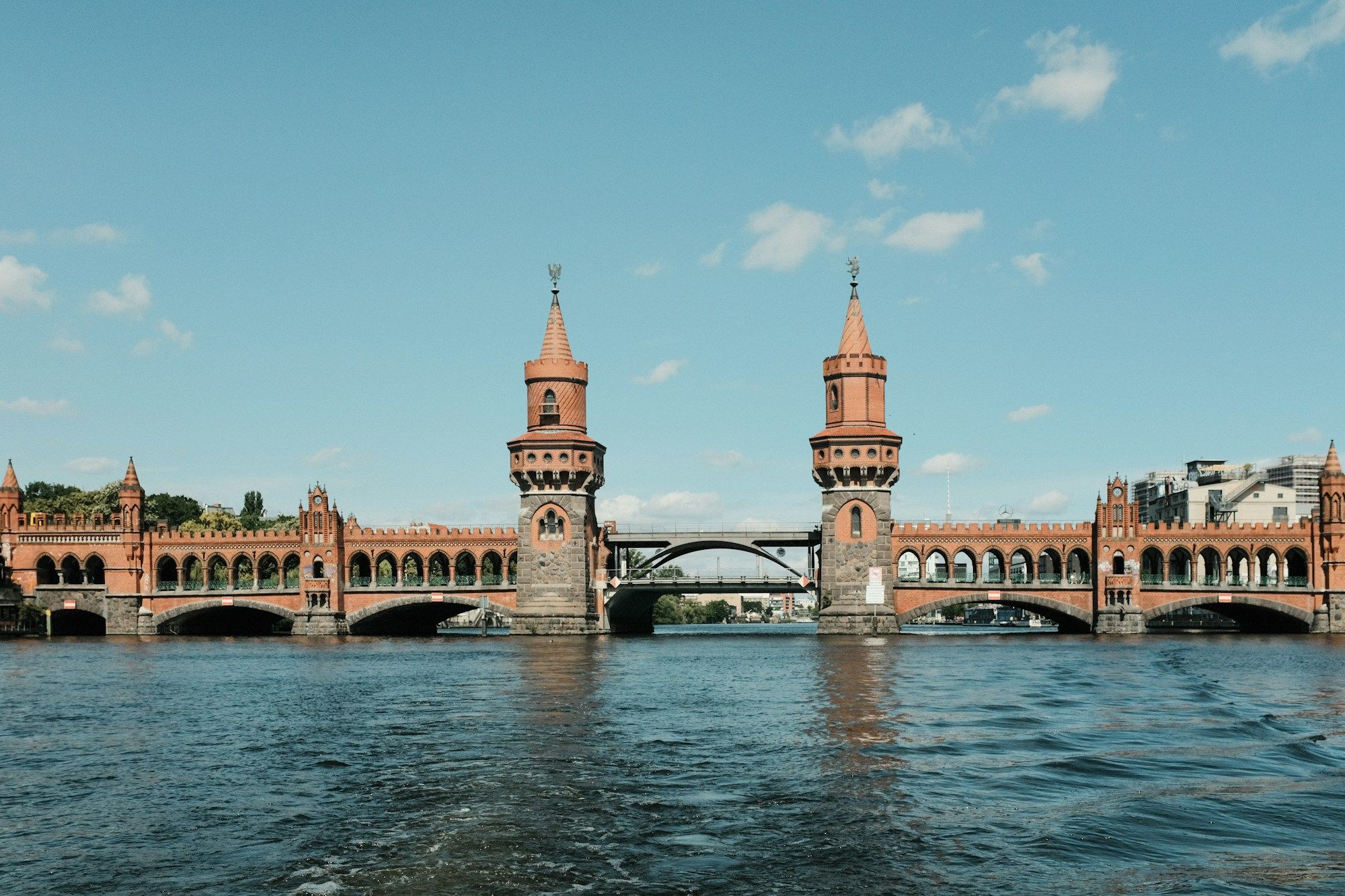 The Oberbaum Bridge over the Spree in Berlin, seen from the water on a sunny day.