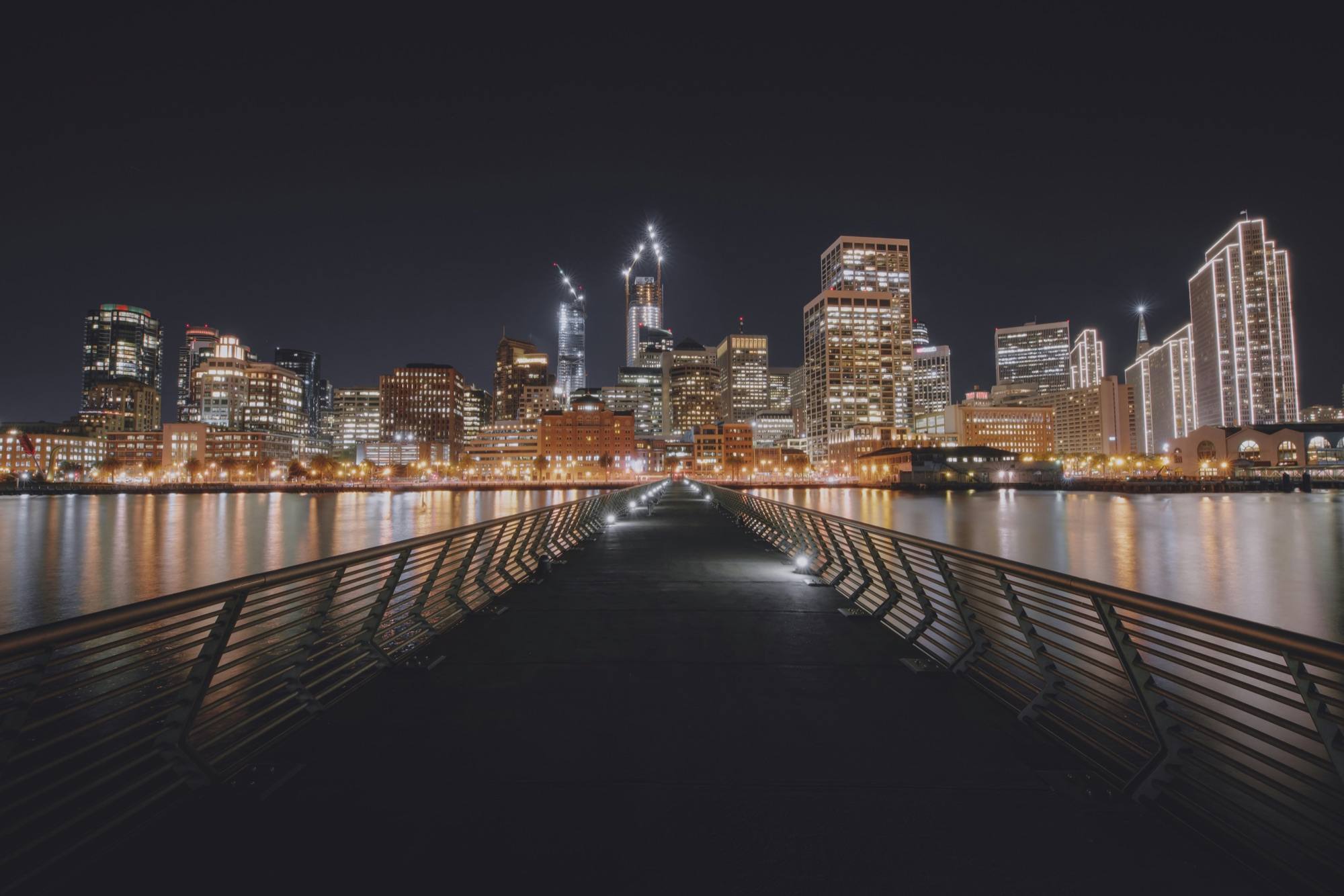 Downtown San Francisco lit up at night, seen from Pier 14 on the Embarcadero