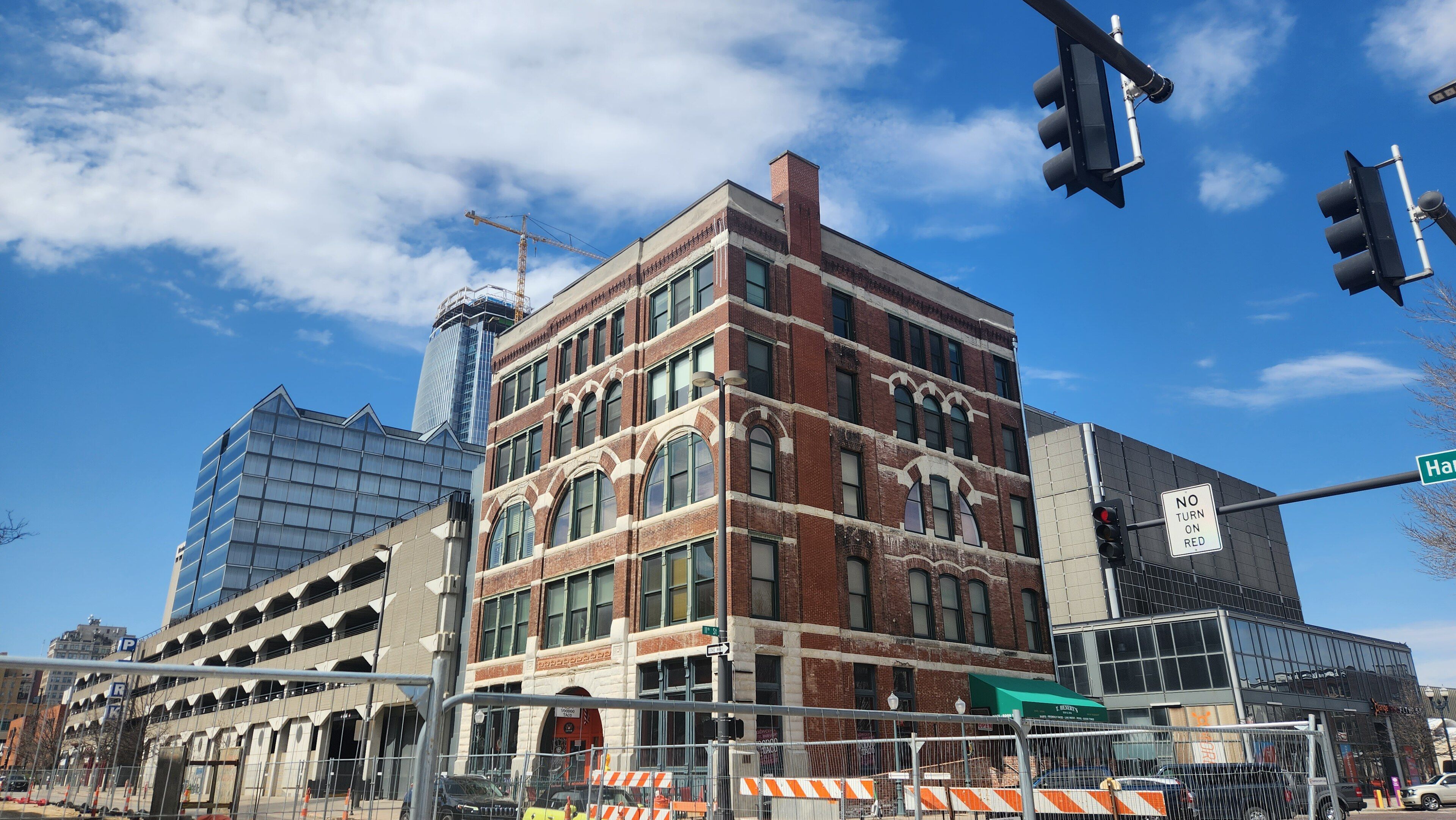 A brick building in the Old Market district of downtown Omaha under a blue sky.
