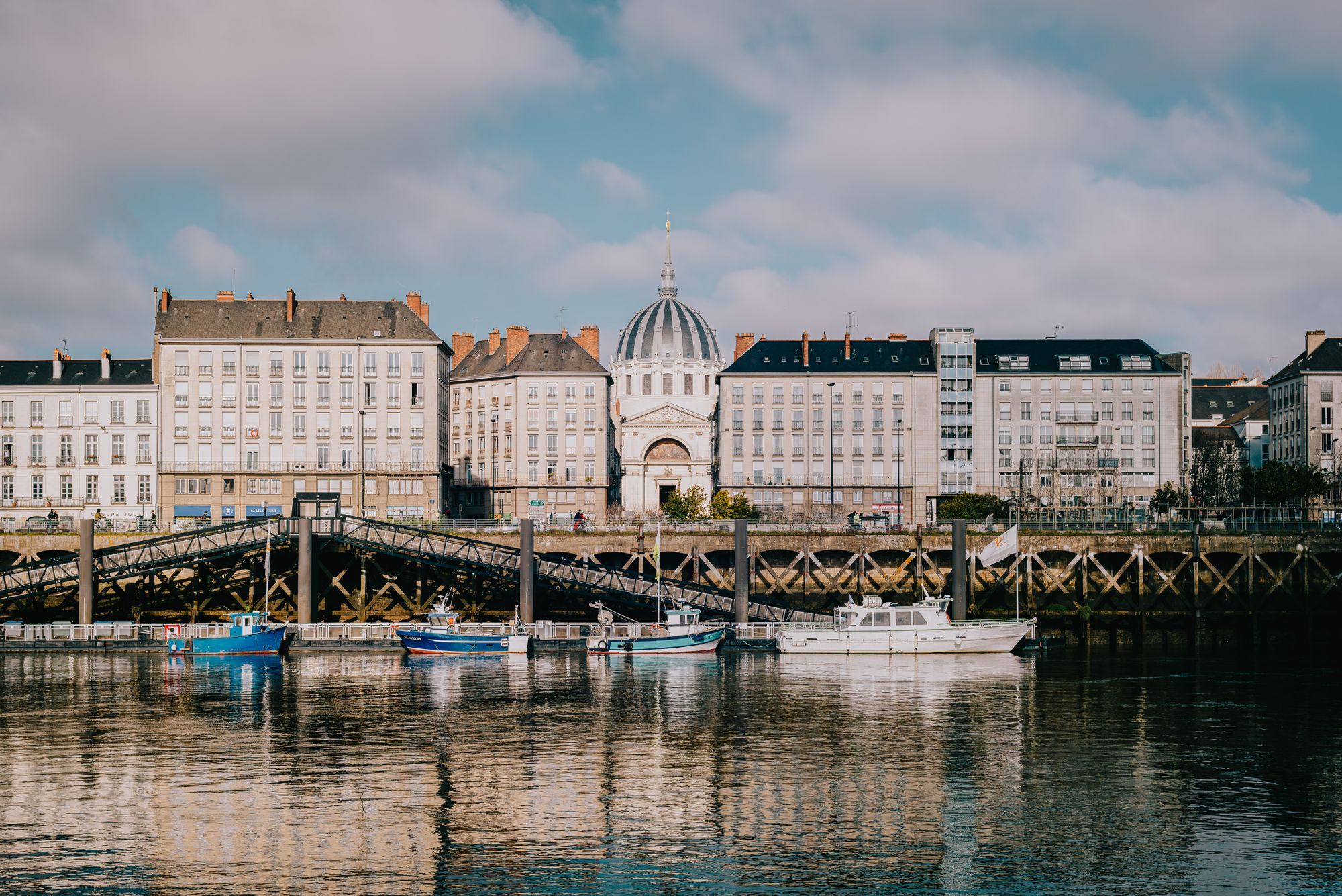 The Loire waterfront in Nantes, with the dome of Notre-Dame de Bon-Port among the quay buildings.