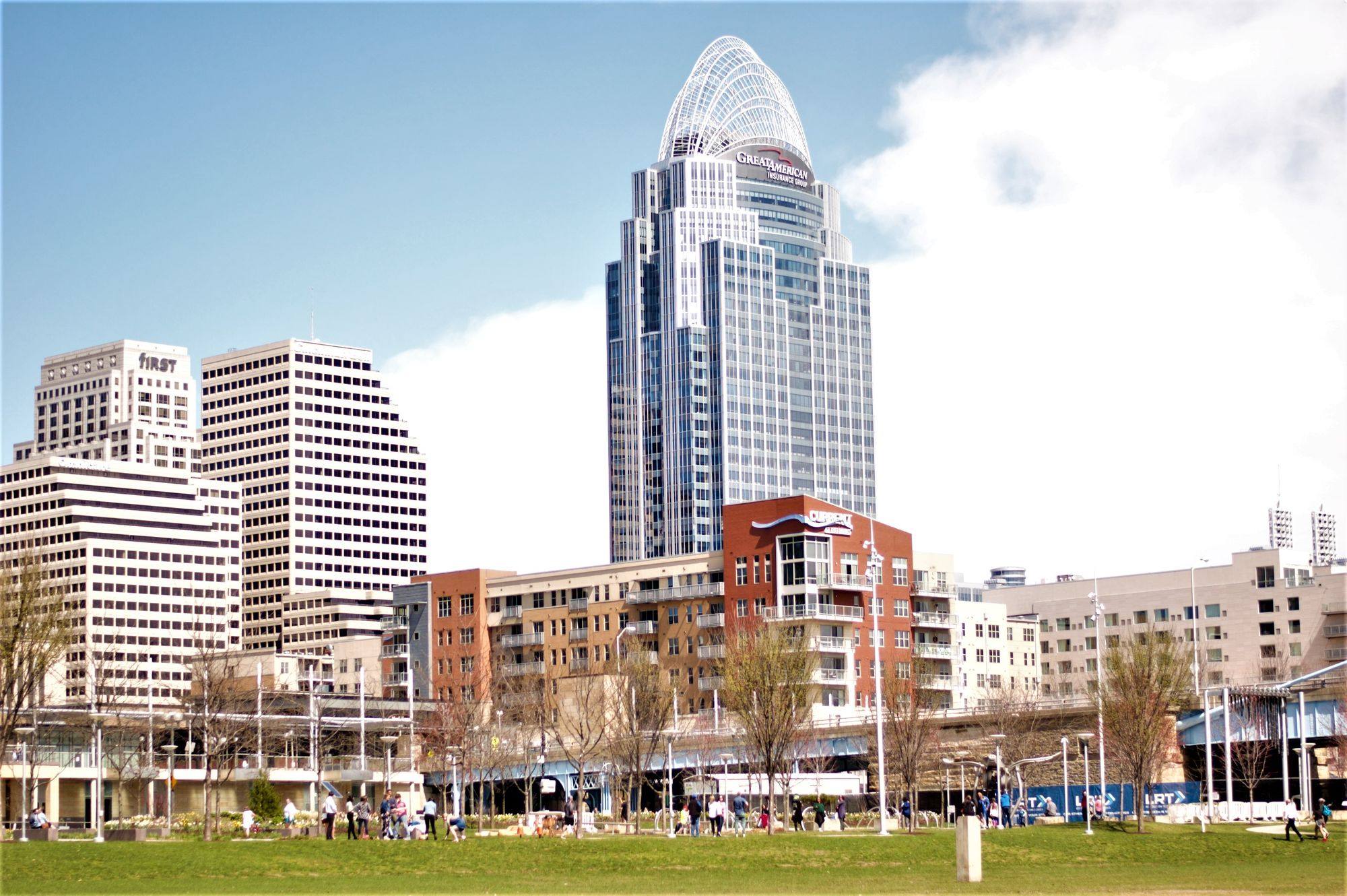 The Great American Tower and other downtown buildings in Cincinnati, seen from a park by the river.