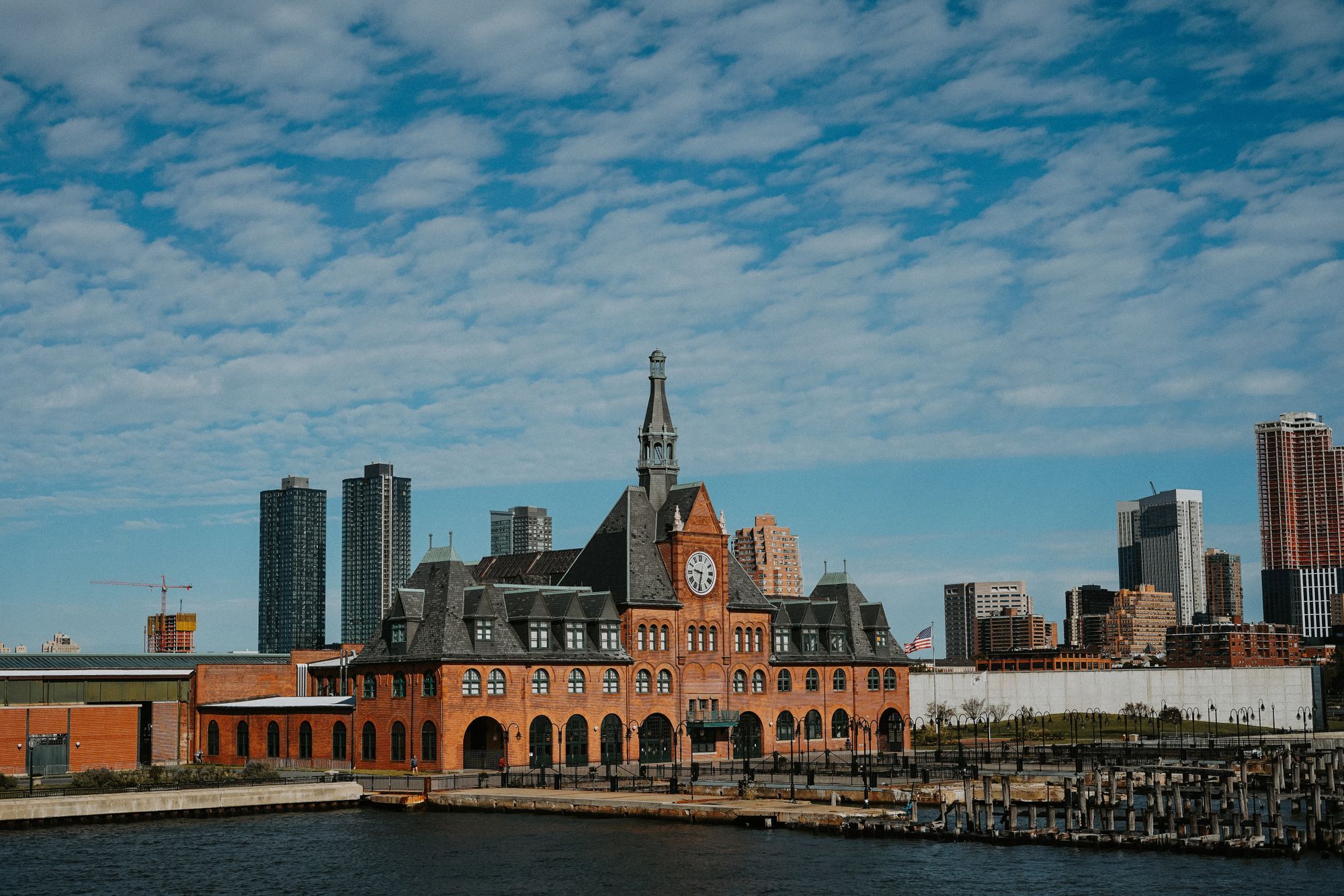 The red-brick Central Railroad of New Jersey Terminal in Liberty State Park, Jersey City, with towers behind it.