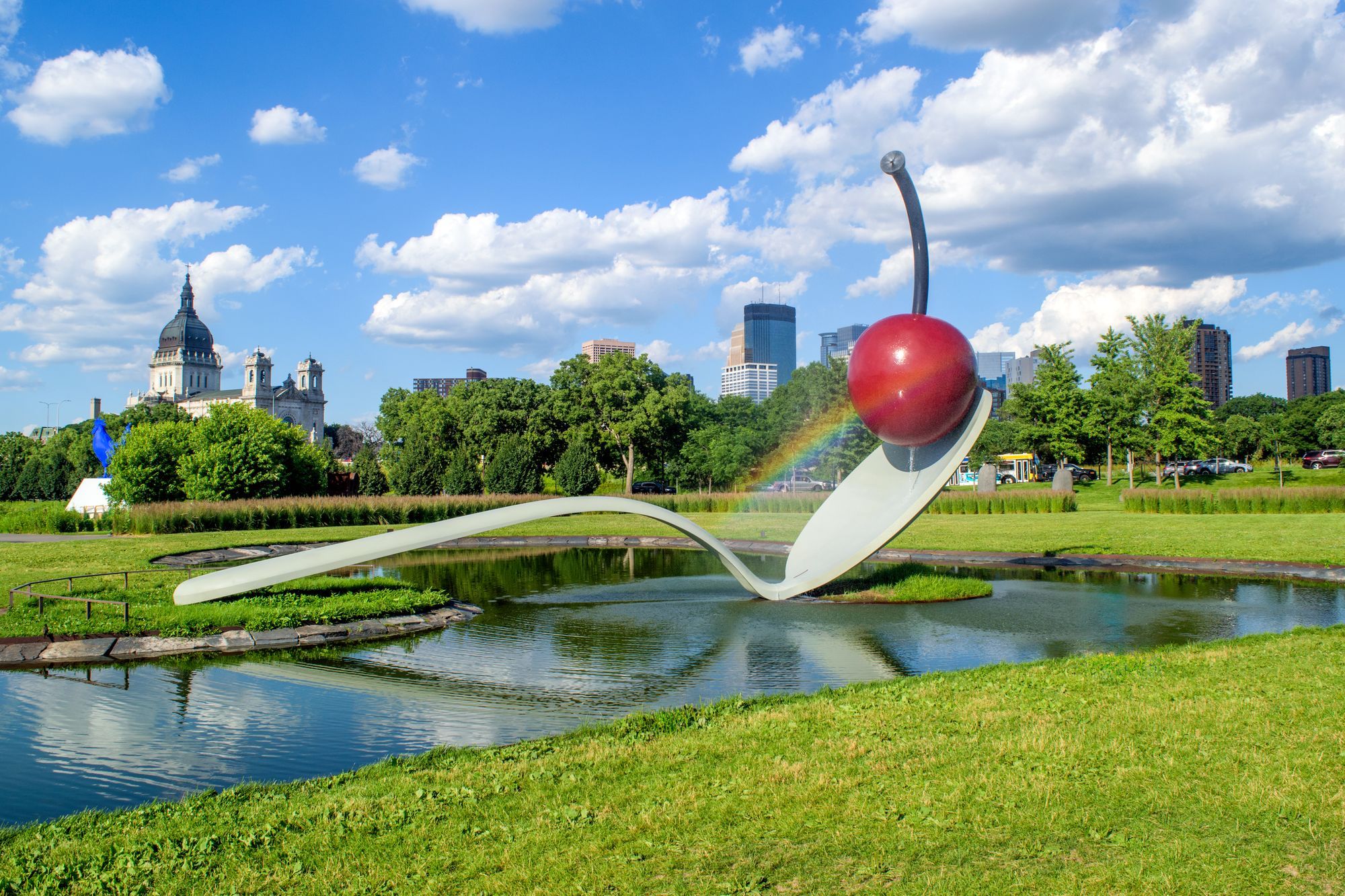 The Spoonbridge and Cherry sculpture in the Minneapolis Sculpture Garden, with the city skyline behind it.
