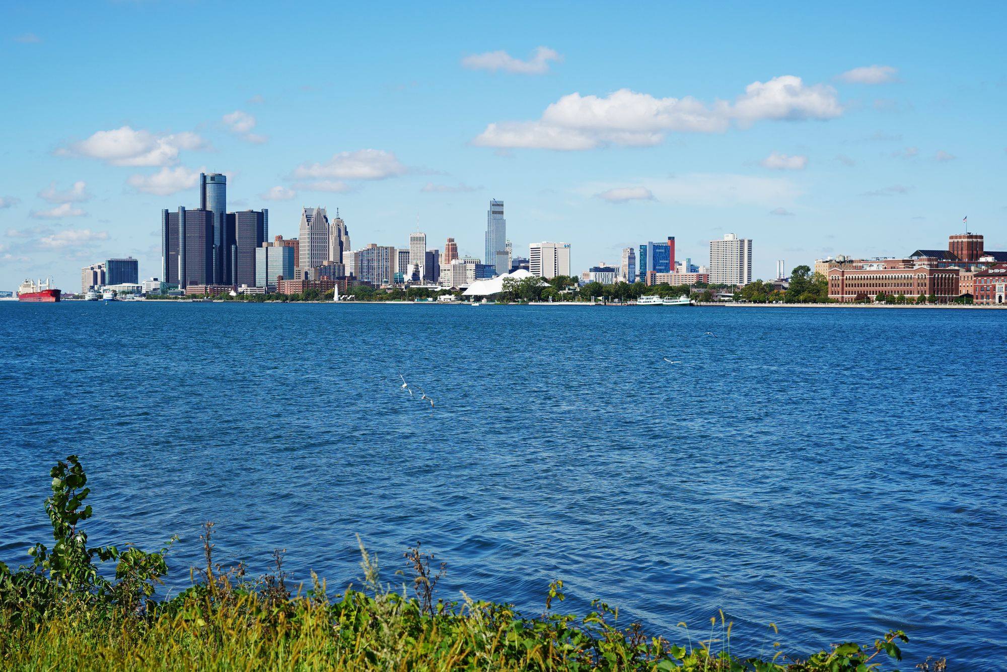The Detroit skyline and the Renaissance Center across the Detroit River on a clear day.