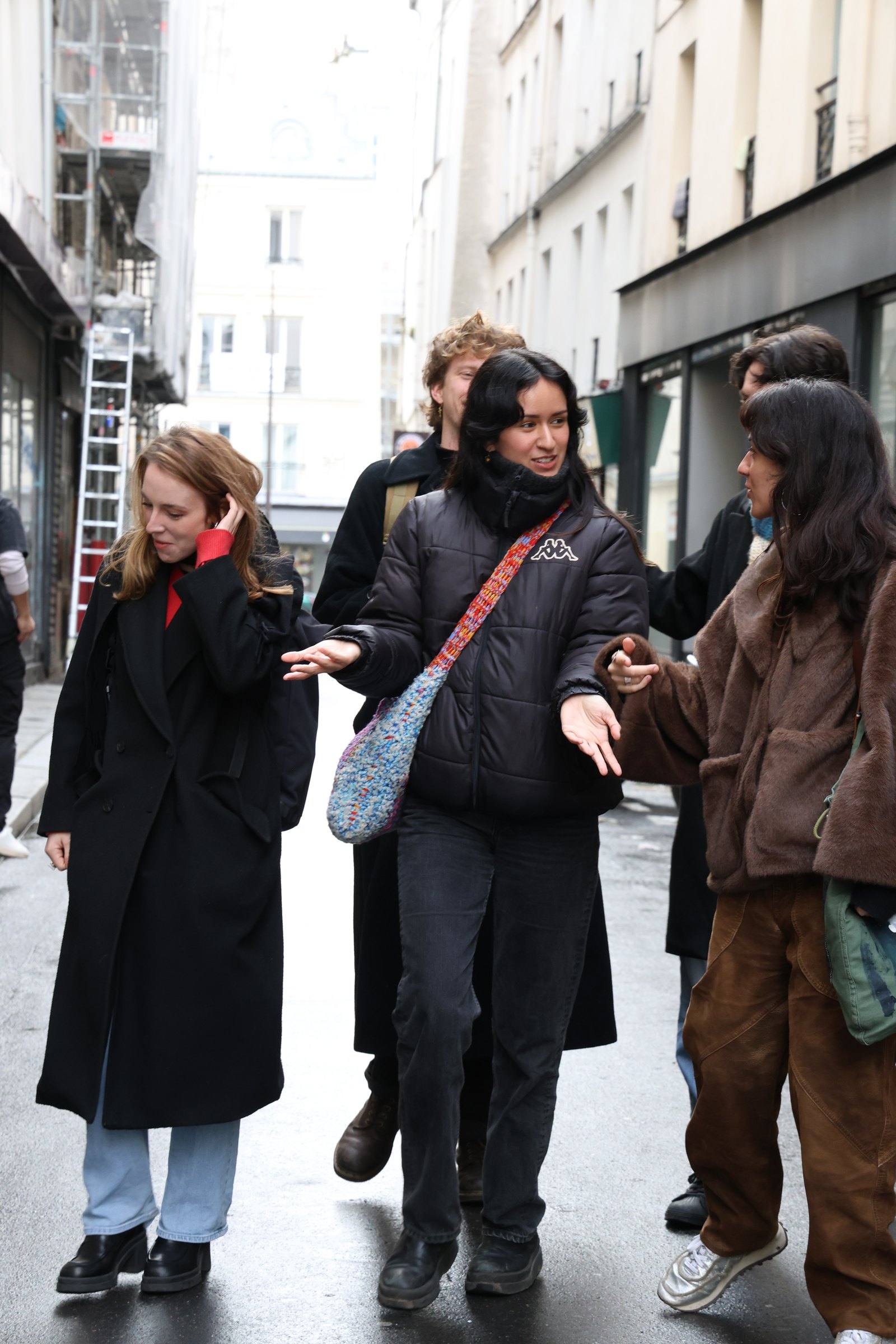 Three women chatting as they walk down a street together