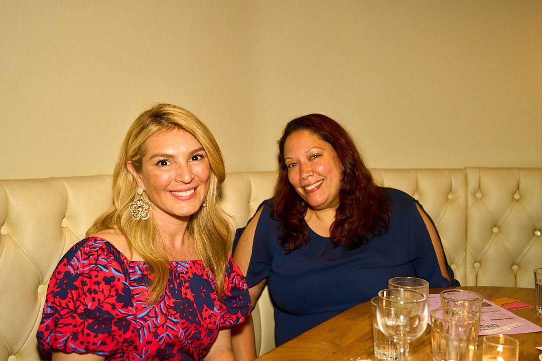 Two women smiling at a women-only Timeleft dinner