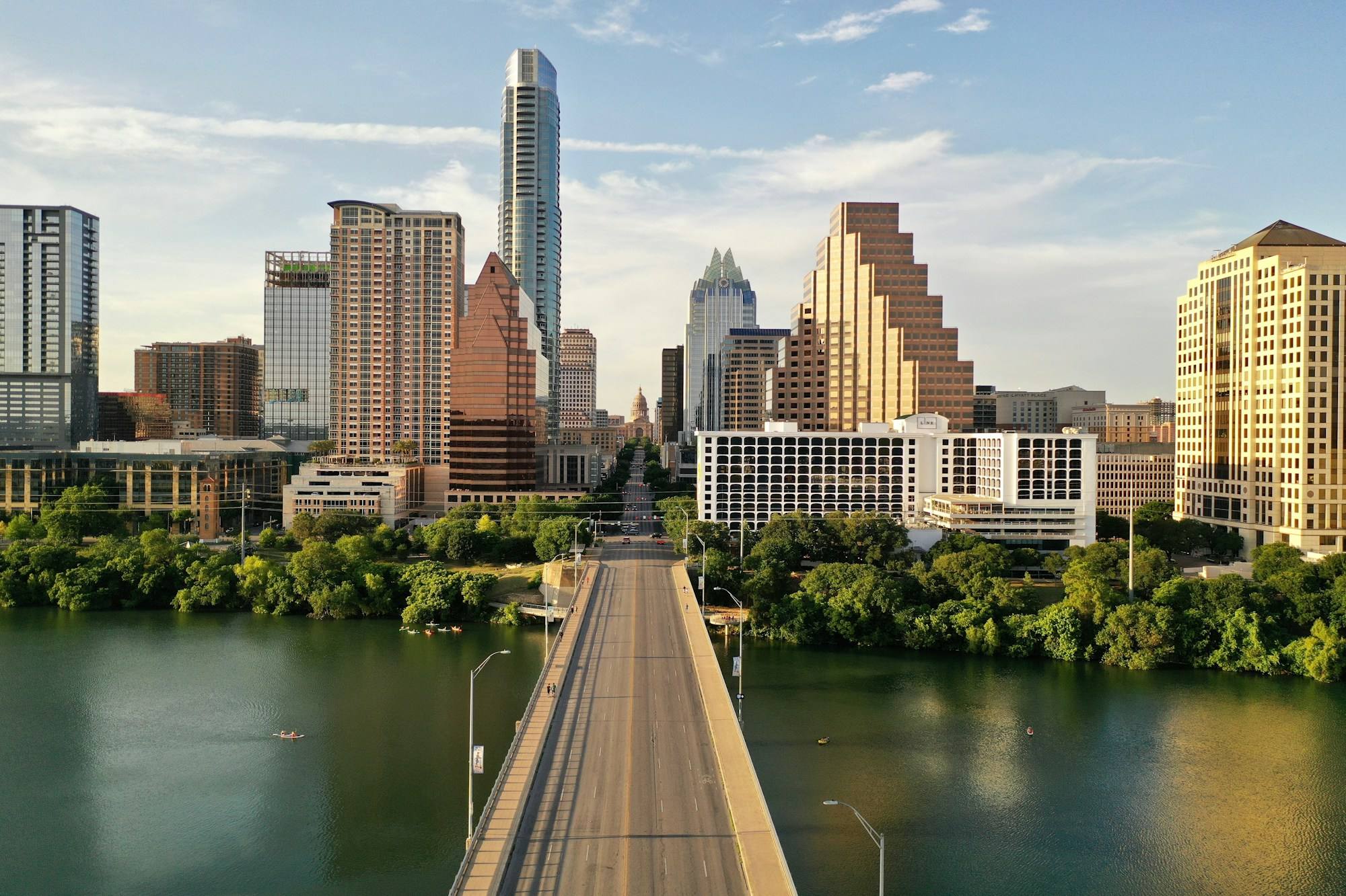 The Congress Avenue Bridge crossing Lady Bird Lake into downtown Austin, with the skyline and the Texas Capitol dome at the end of the avenue