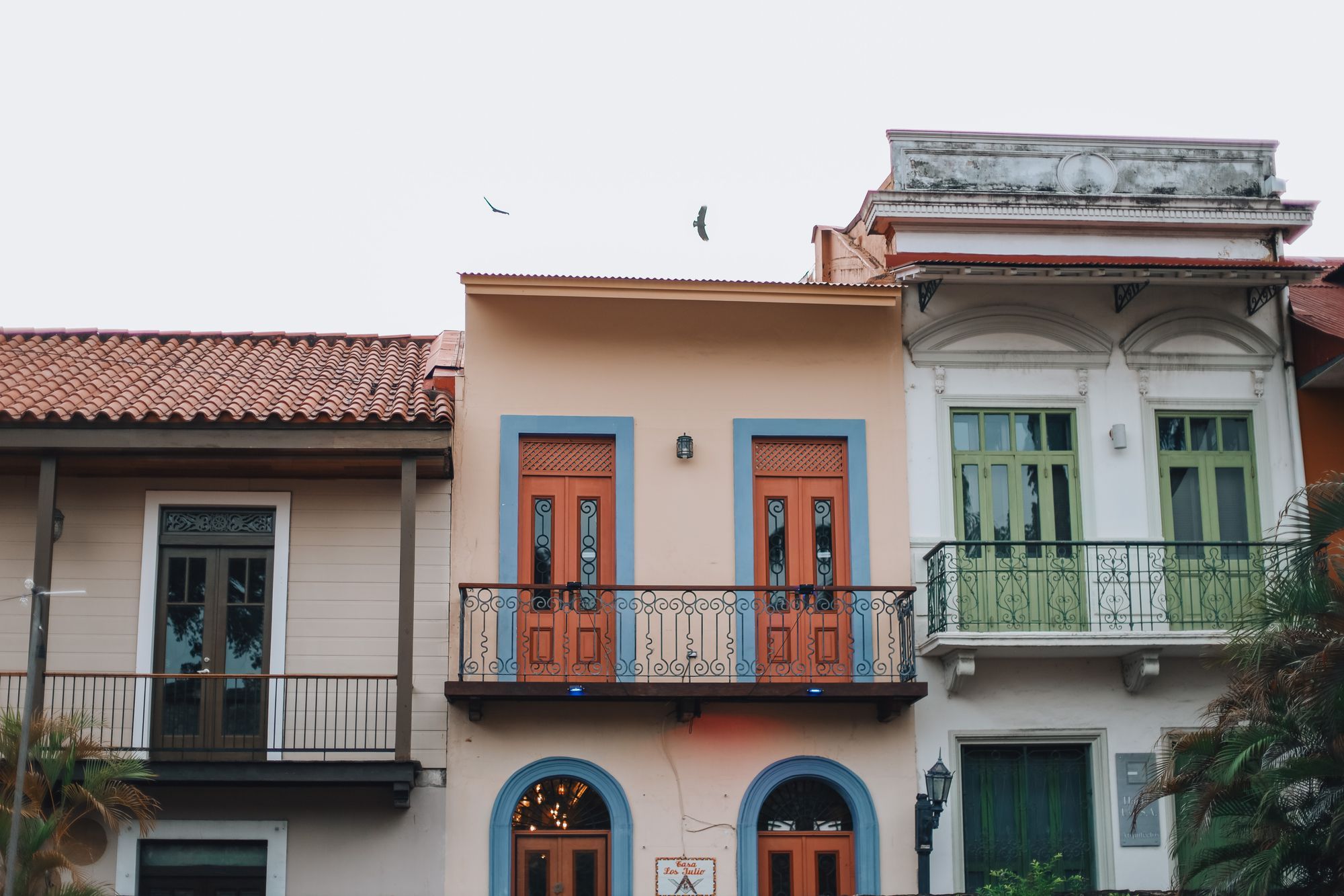 Colonial houses with wooden balconies and arched doors in the Casco Viejo of Panama City.