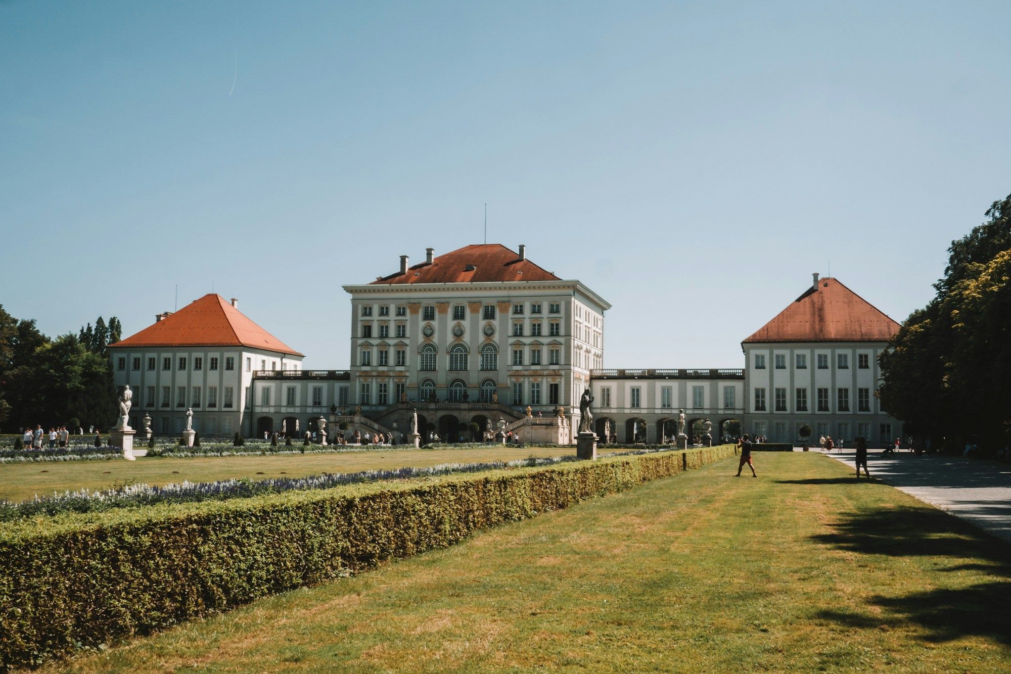 Nymphenburg Palace in Munich seen across the lawn of its garden on a clear day.