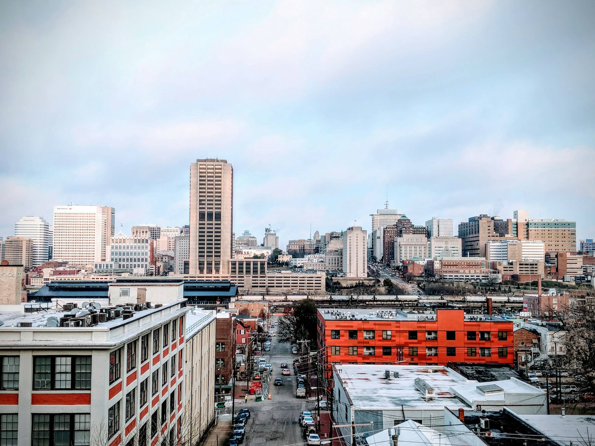 The downtown Richmond skyline above a street of brick warehouses