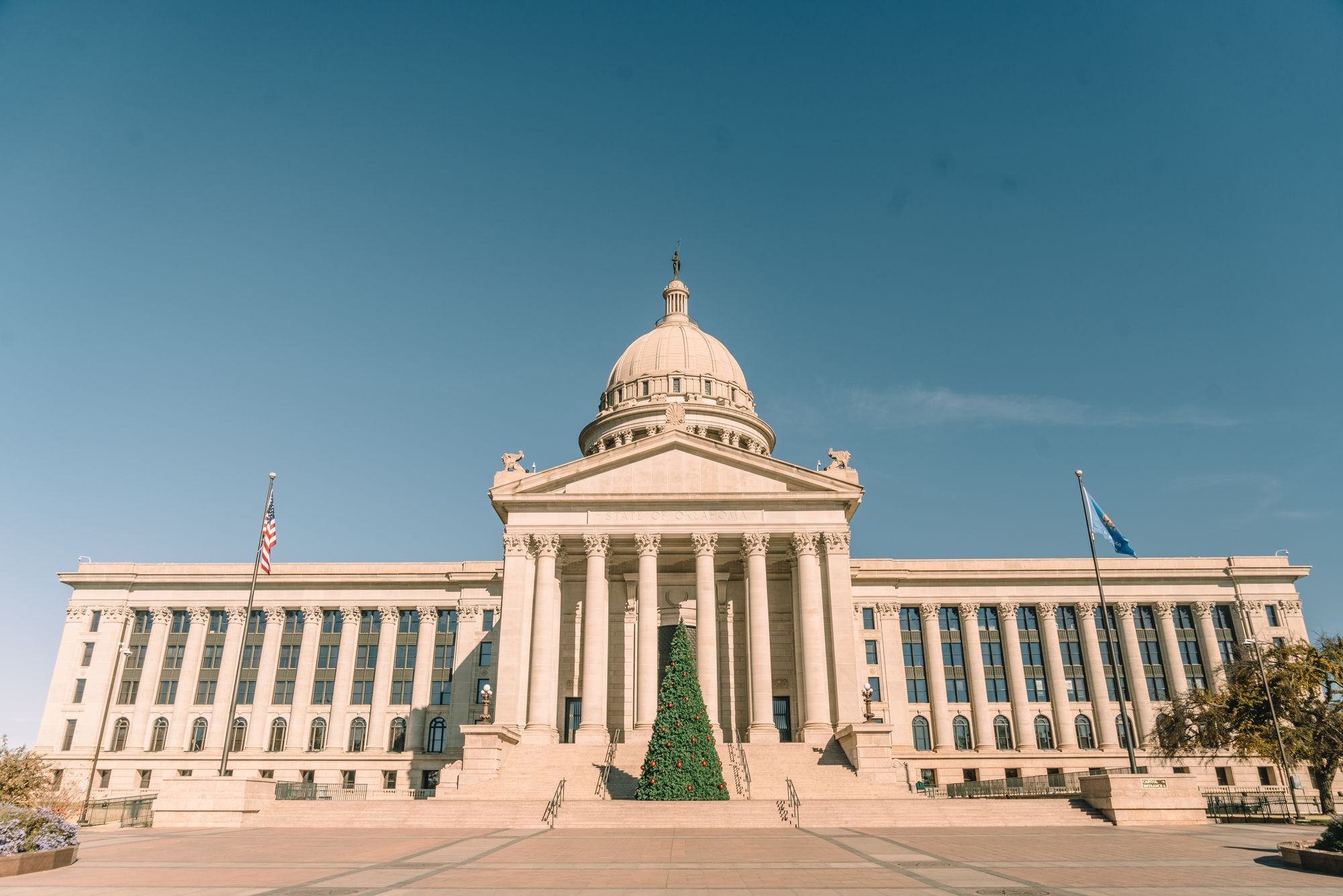 The Oklahoma State Capitol building under a blue sky in Oklahoma City.