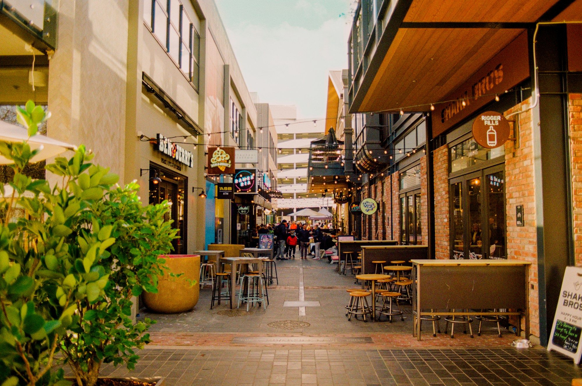 A pedestrian lane lined with café tables and string lights in central Christchurch