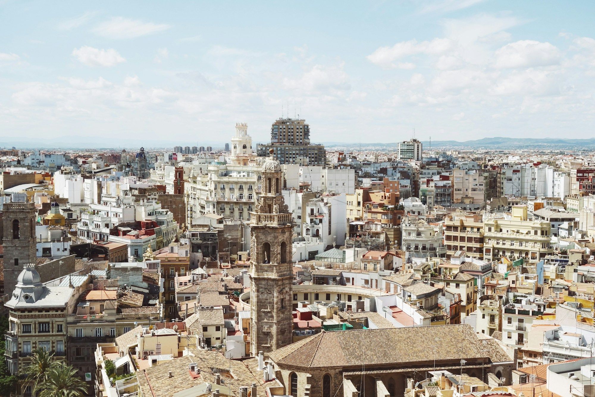 The rooftops of Valencia's old town seen from above, with a baroque bell tower among the buildings.