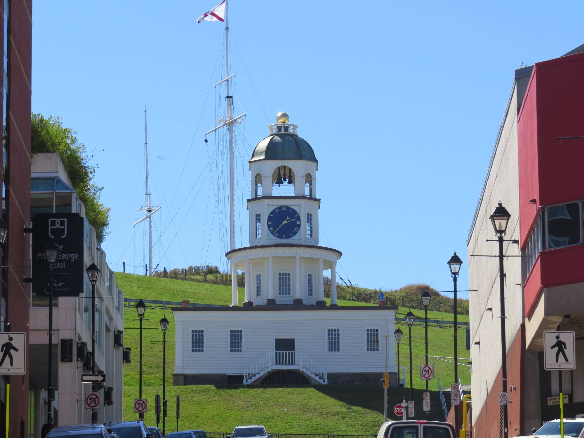 The Halifax Town Clock on the slope of Citadel Hill, with a flag pole beside it.