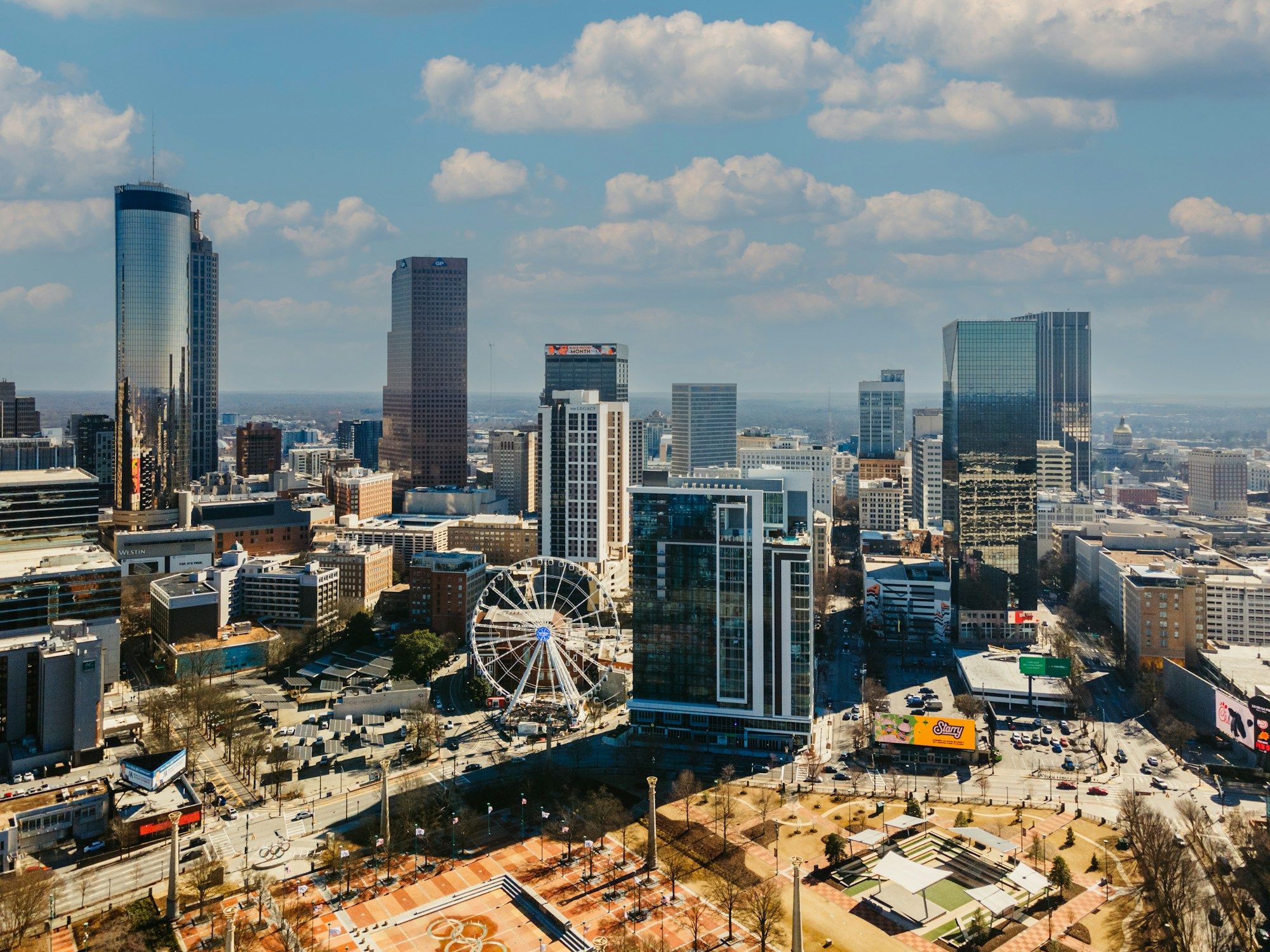 The downtown Atlanta skyline from above, with the SkyView Ferris wheel at the edge of Centennial Olympic Park.