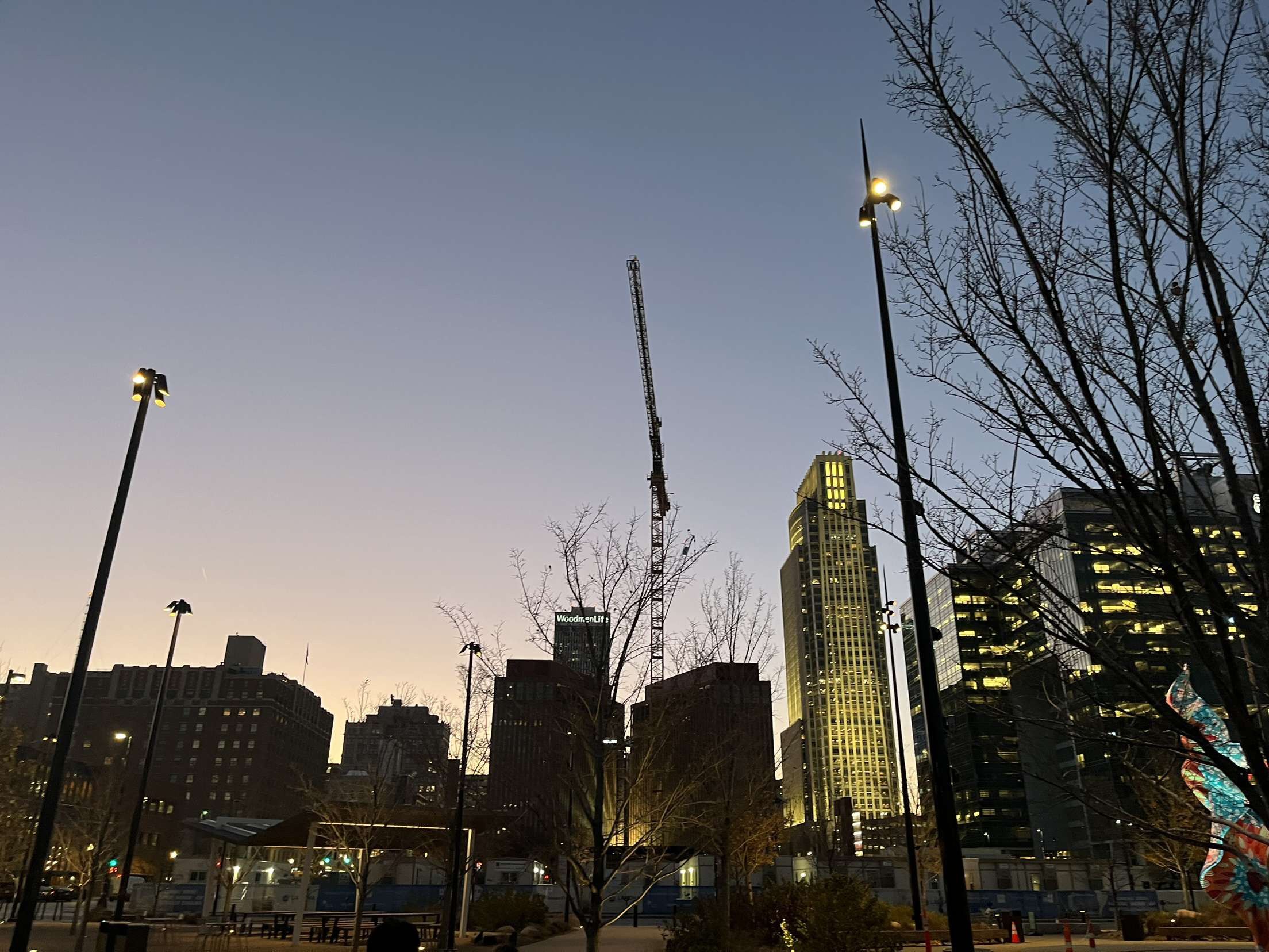 Downtown Omaha at dusk, with the Woodmen Tower beside Gene Leahy Mall.