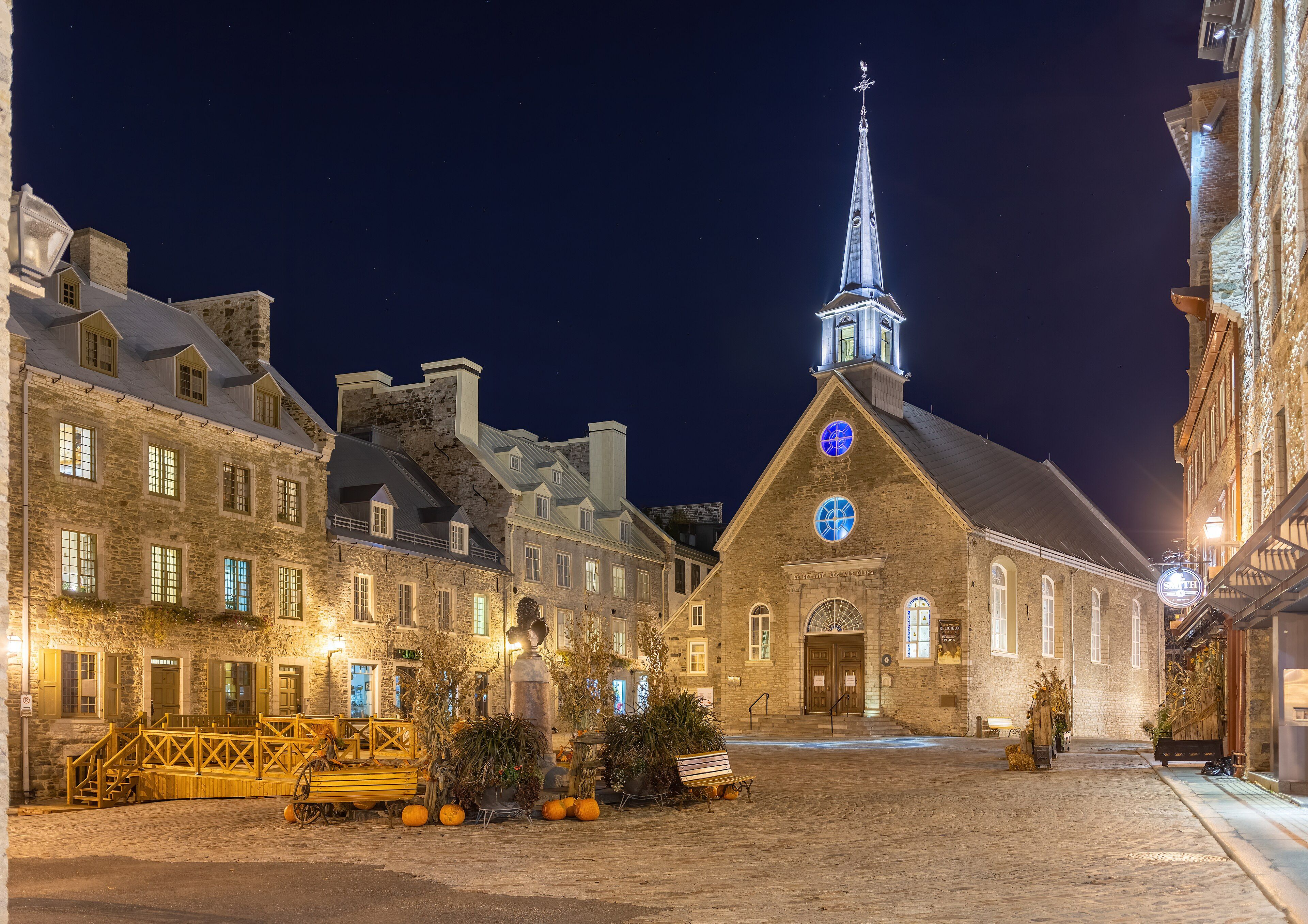 Place Royale and the church of Notre-Dame-des-Victoires lit at night in the Lower Town of Quebec City.