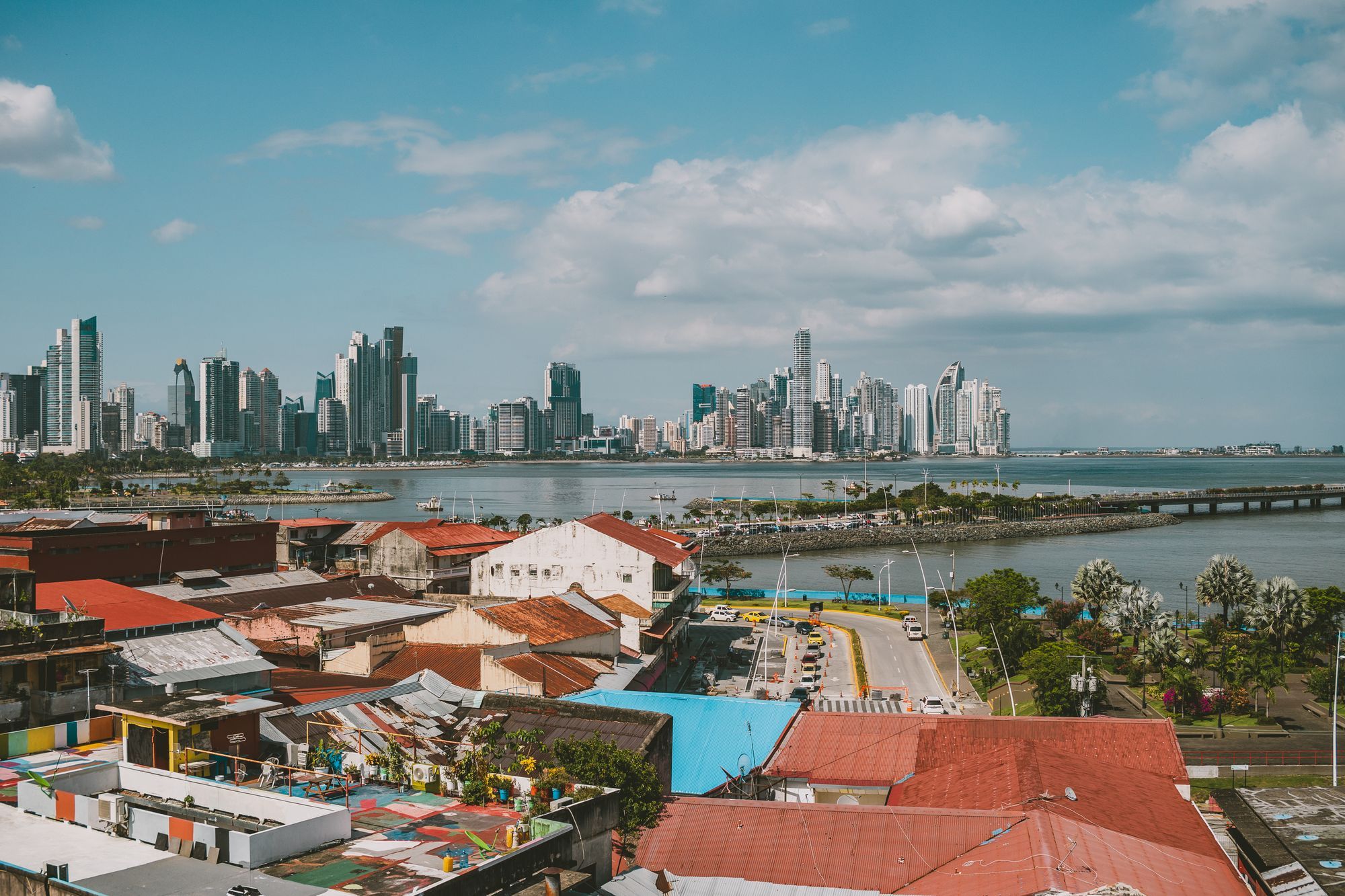 Casco Viejo rooftops in front of the Panama City skyline across the bay.