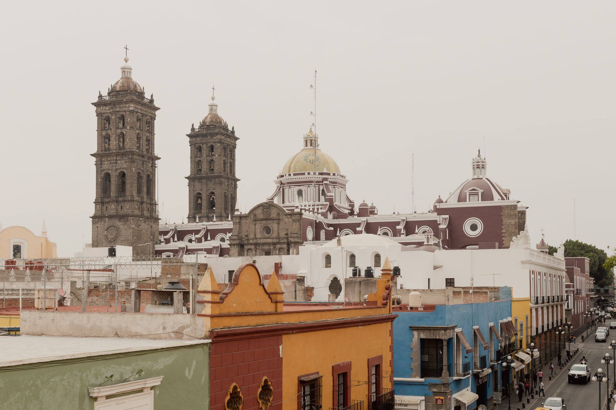 The towers and dome of Puebla Cathedral above the rooftops of the historic center.