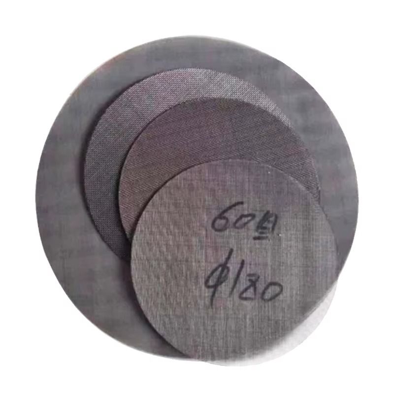 Extruder screen discs inspected under optical equipment