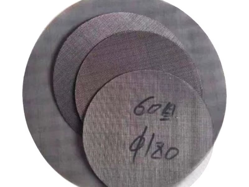 Extruder screen discs inspected under optical equipment