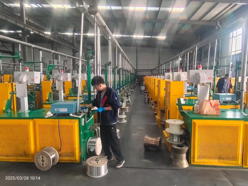 KAIFIL operator checking a wire drawing machine line in the factory workshop