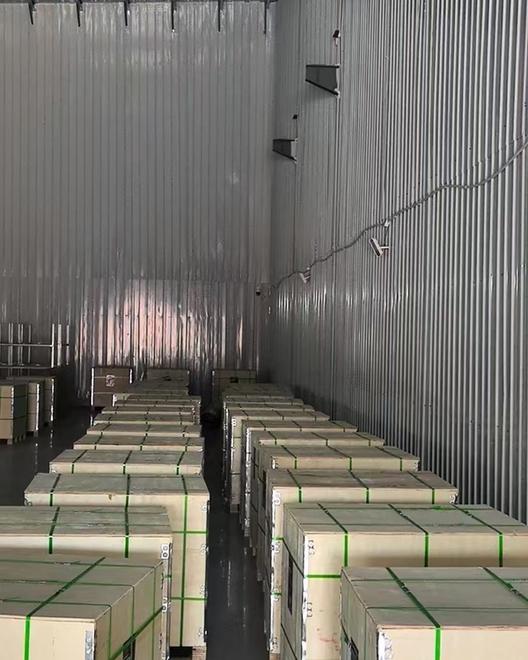 Rows of export wooden crates with green strapping staged in the warehouse before shipment