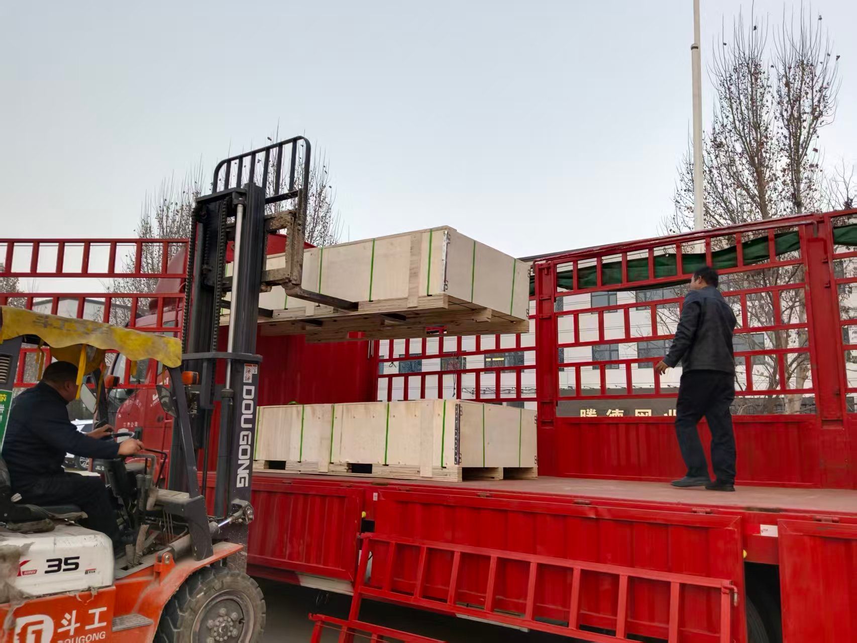 Export packing: wooden crates loaded onto a truck at the factory gate
