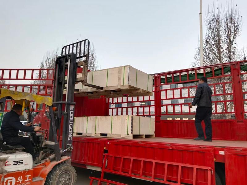 Export packing: wooden crates loaded onto a truck at the factory gate