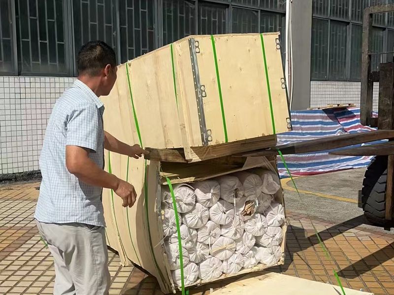 Wire mesh rolls packed in a strapped wooden crate before export shipment