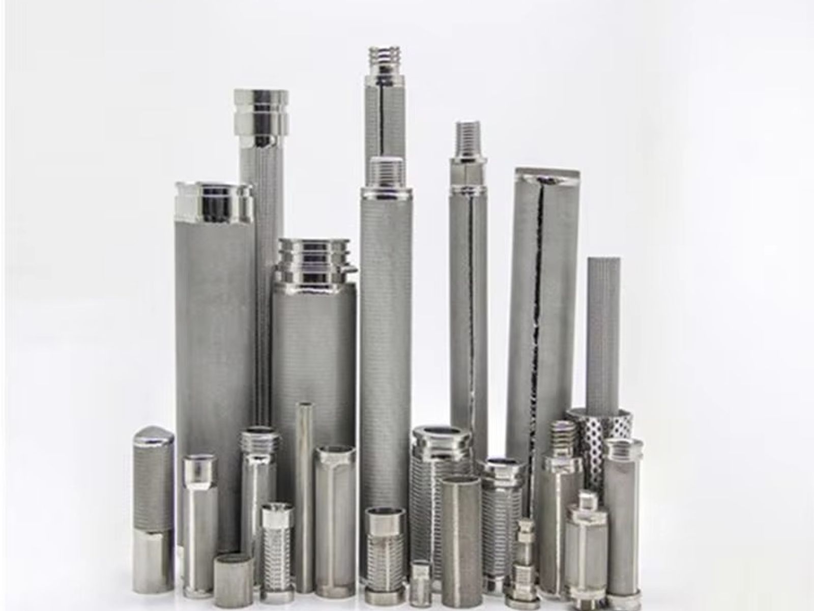 Wire mesh filter cartridge samples on a factory workbench