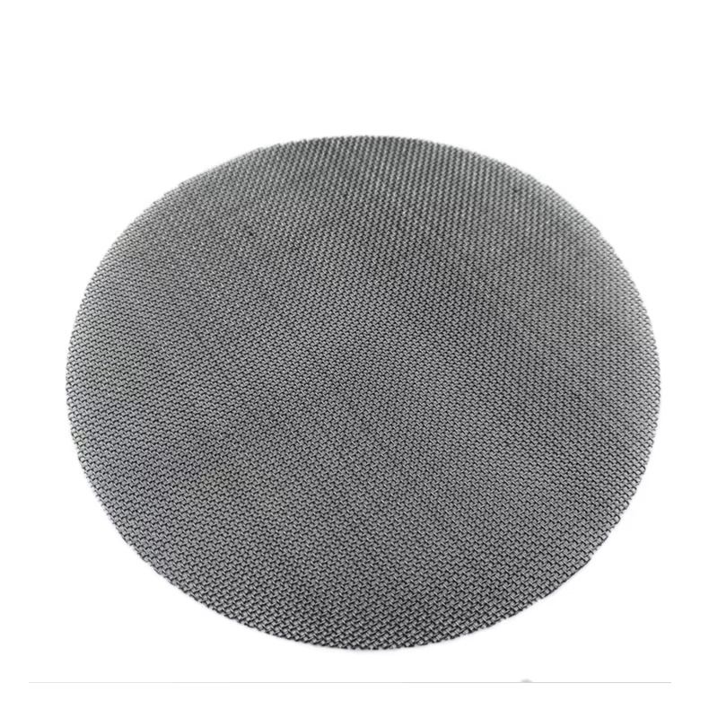 Close-up of a multi-layer extruder screen pack with breaker plate — stainless steel mesh discs used in plastic recycling melt filtration