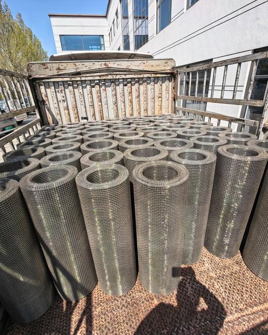 Bulk shipment of galvanized wire mesh rolls loaded on a truck at the factory yard